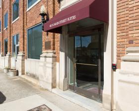 Glass door with burgundy awning