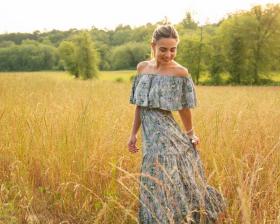 girl in field wearing a dress