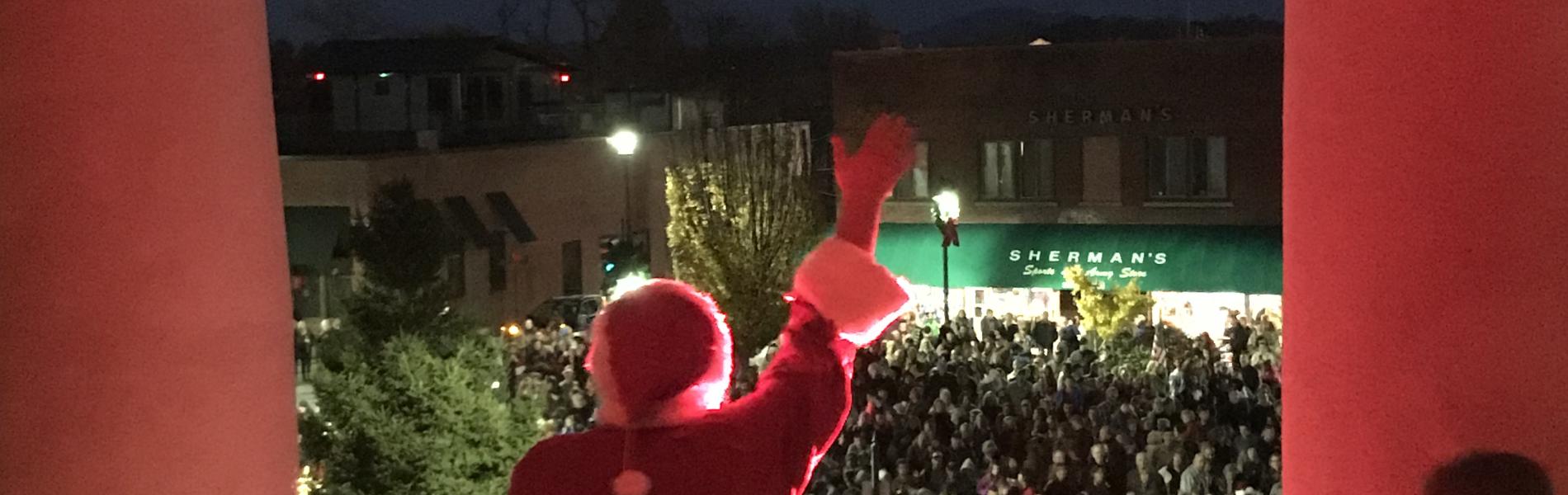 Santa looking over a balcony to the crowd
