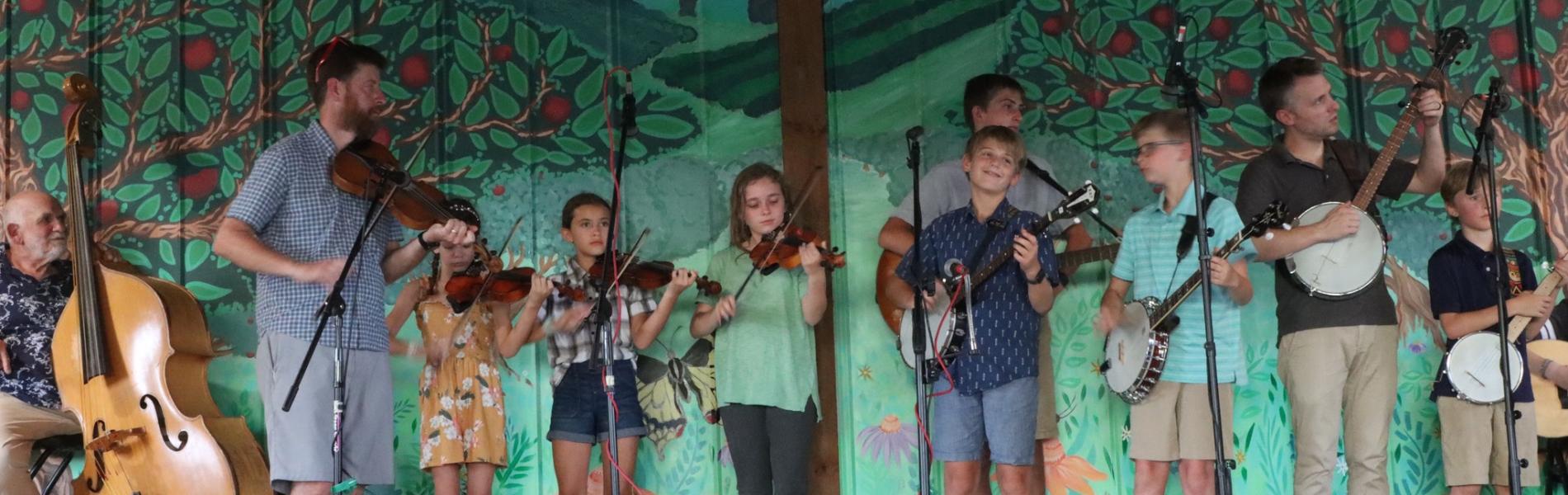 kids playing banjos and other string instruments