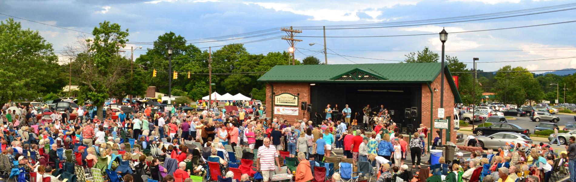 crowd sitting and watching music