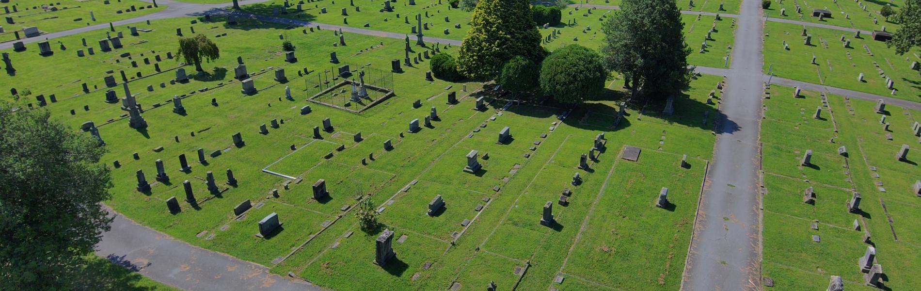 Aerial photo of Oakdale Cemetery showing bright green grass and headstones on a sunny day.
