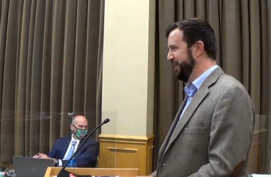 Man giving a speech at a podium