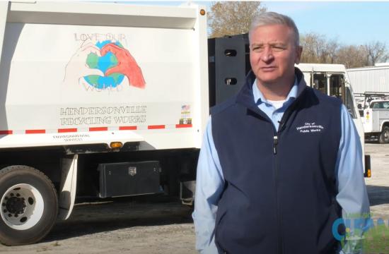 Man beside a recycling truck