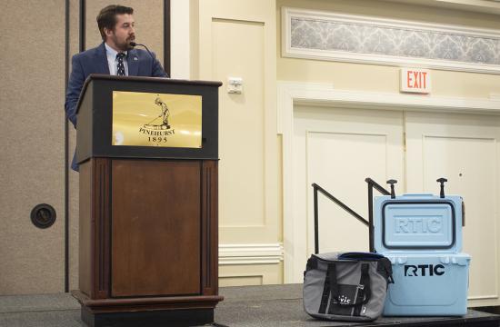 man giving speech from podium