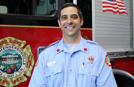 Assistant Fire Marshal standing in front of truck