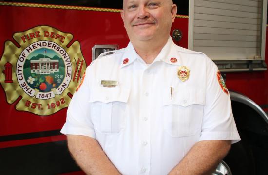 Fire Marshal standing in front of fire truck