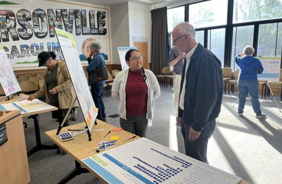 lady and man standing in front of poster