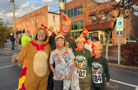 Family at a turkey trot race wearing turkey hats