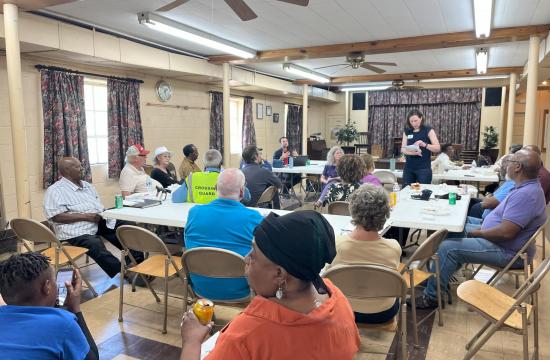 Community meeting with people at tables
