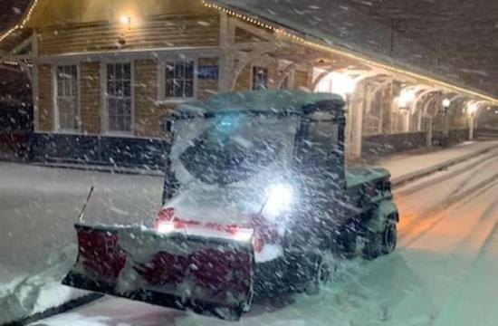 Vehicle plowing snow in front of the train depot