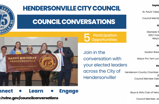 council members holding banner