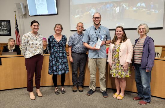 Mike Huffman smiling, standing with five individuals from the Hendersonville Sustainability Board.