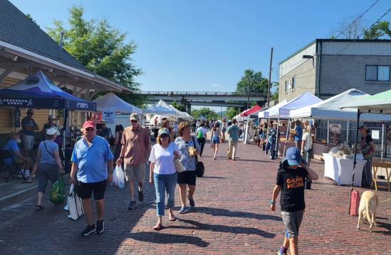 Hendersonville Farmers Market day with visitors walking around