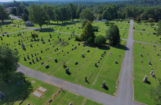 Aerial photo of Oakdale Cemetery, showing bright green grass and headstones on a sunny day.