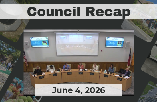 Council members are seated around a dais.