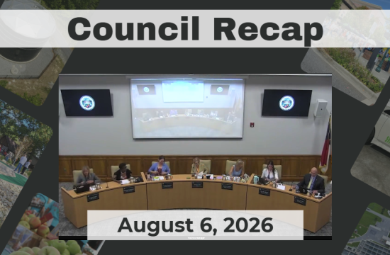 Council members are seated around a dais.