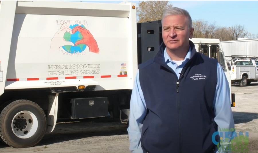 Man beside a recycling truck