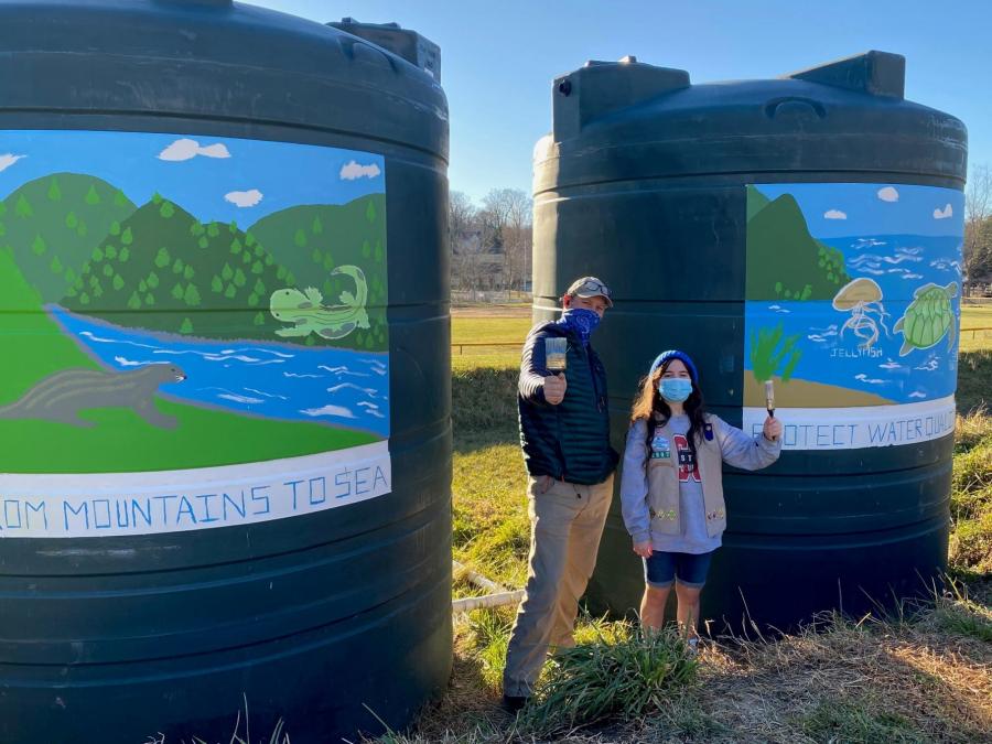Man and girl with rainwater cisterns