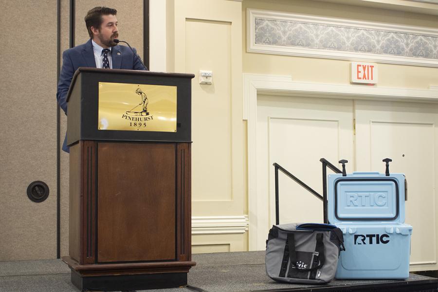 man giving speech from podium