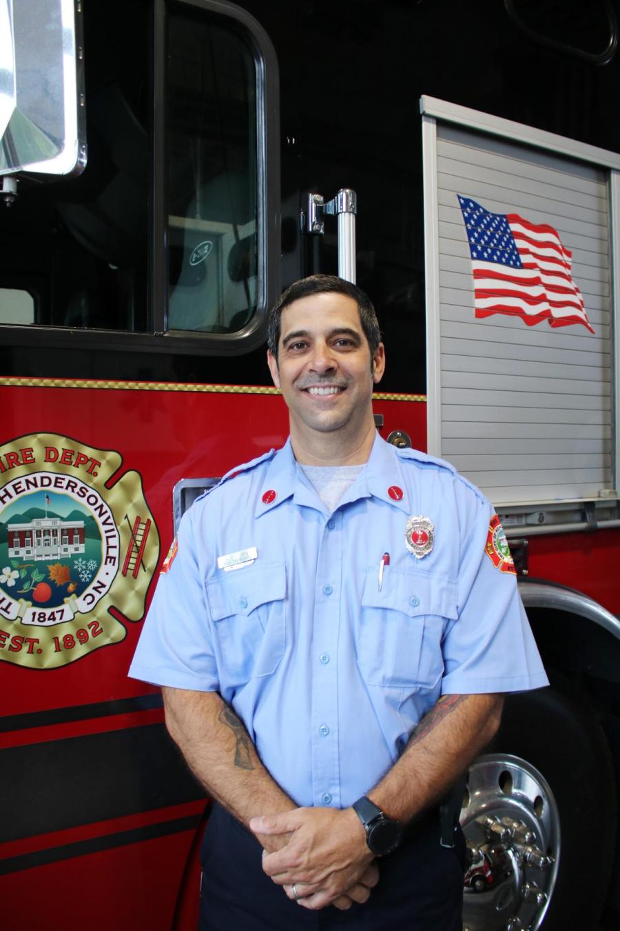 Assistant Fire Marshal standing in front of truck
