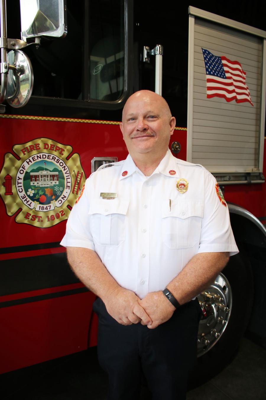 Fire Marshal standing in front of fire truck