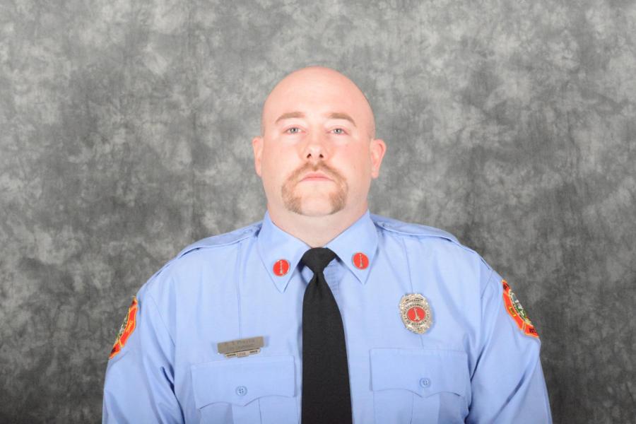 firefighter in blue shirt and tie uniform