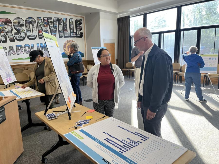 lady and man standing in front of poster