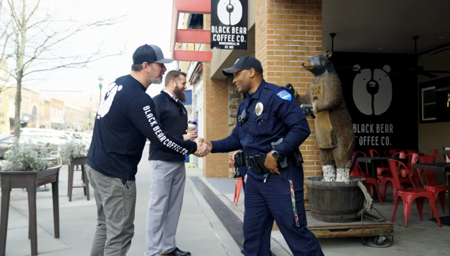 officer shaking hands with community member