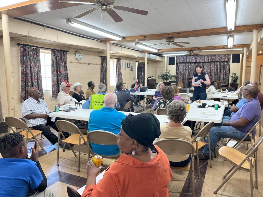 Community meeting with people at tables