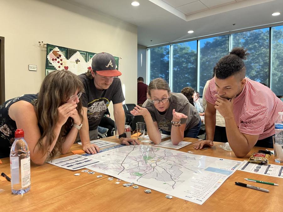 4 people looking at a map