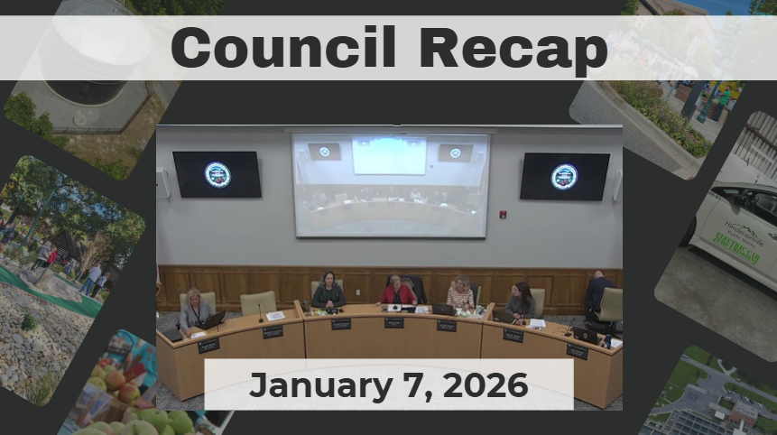 City Council members sit a rounded dias. 