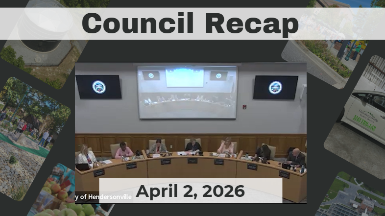 Council members are seated around a dais. 