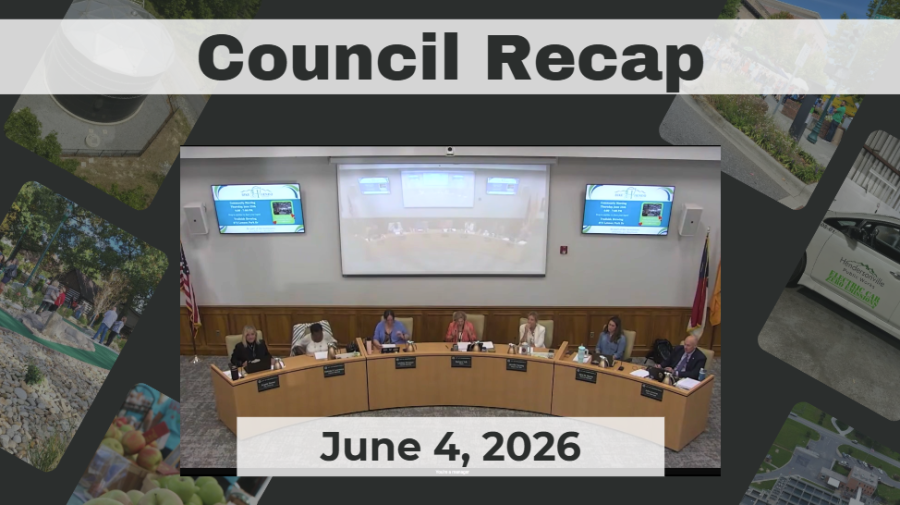 Council members are seated around a dais. 