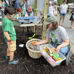 Kid and woman playing with food waste activity