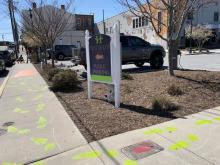 sidewalk corner with footprints painted