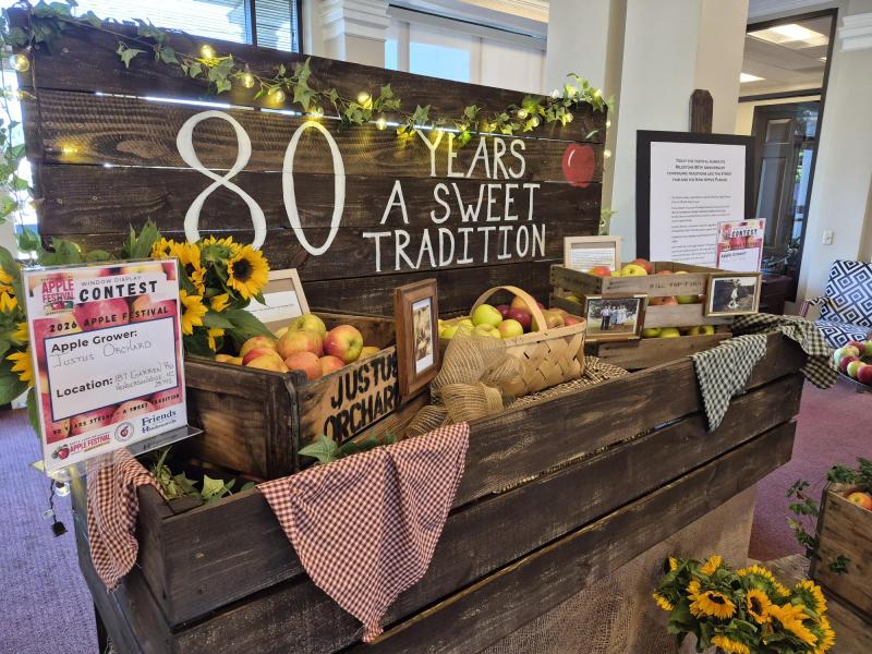 image of apple display that features text that says 80 years, a sweet tradition, with apples