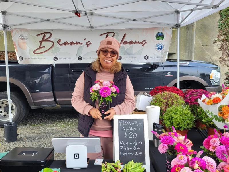 Vendor from GO Pink Day wearing pink and selling flowers