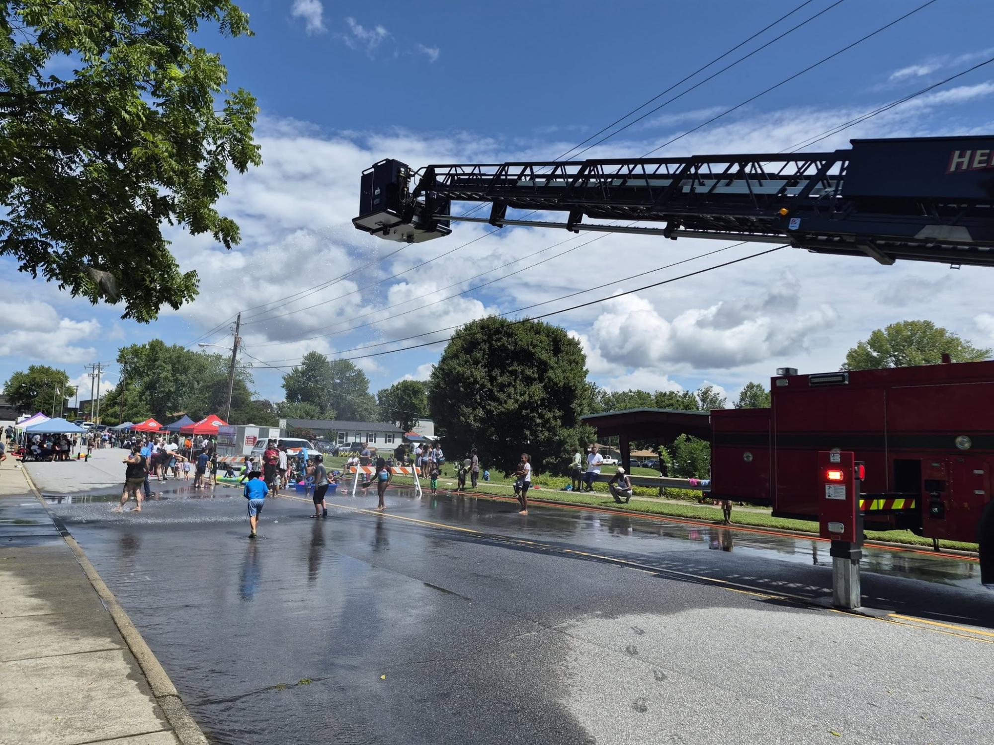 Fire truck and resource tents at a community splash day event