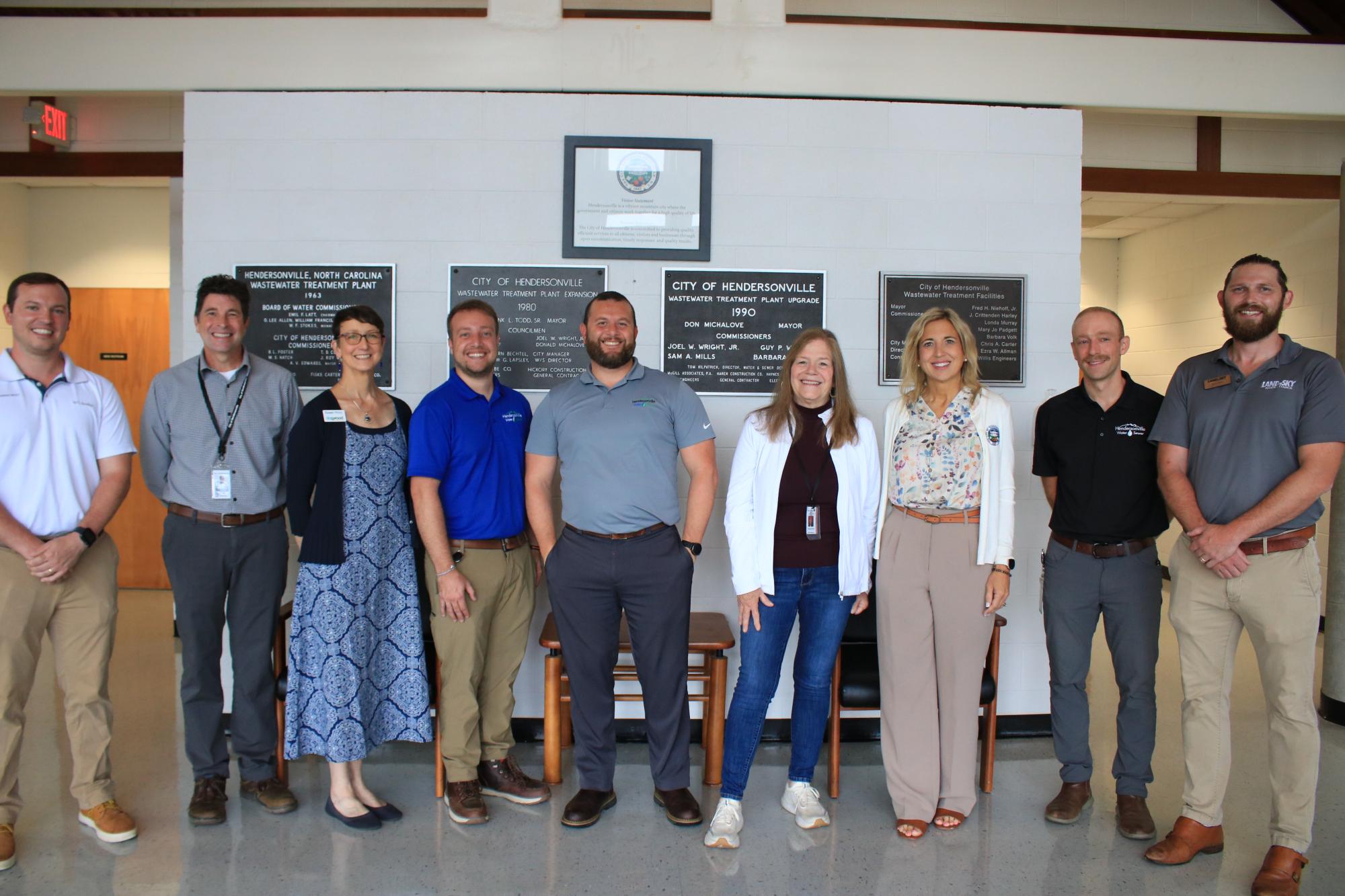 Row of people at the Wastewater treatment facility lobby smiling