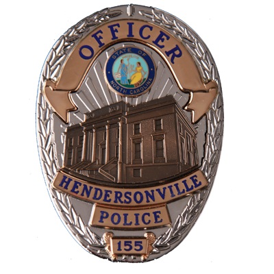 police badge. Silver and gold with a city hall emblem on it.