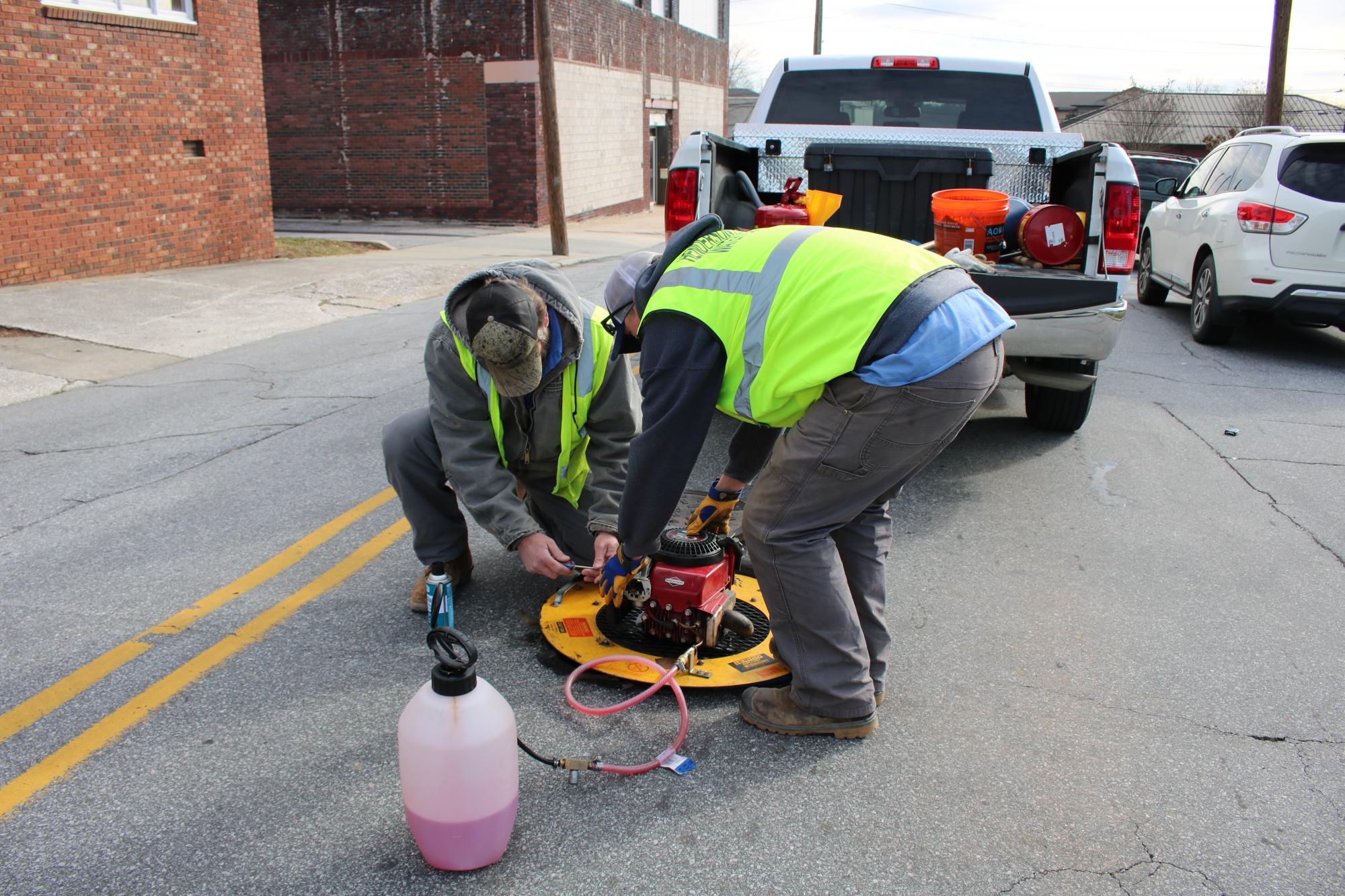 2 crew members working near a manhole