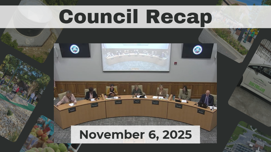 City Council members are seated around a curved dais. 