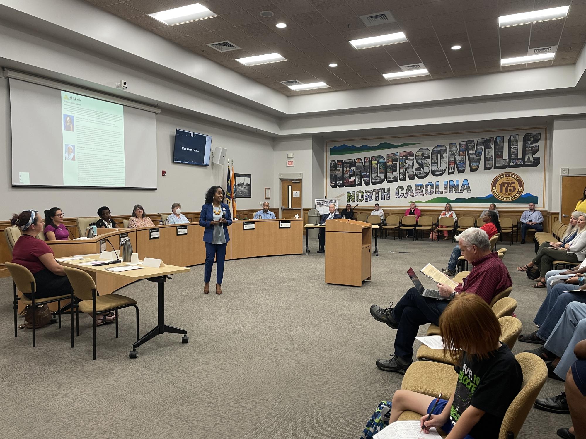 Woman presenting at a Diversity Committee meeting