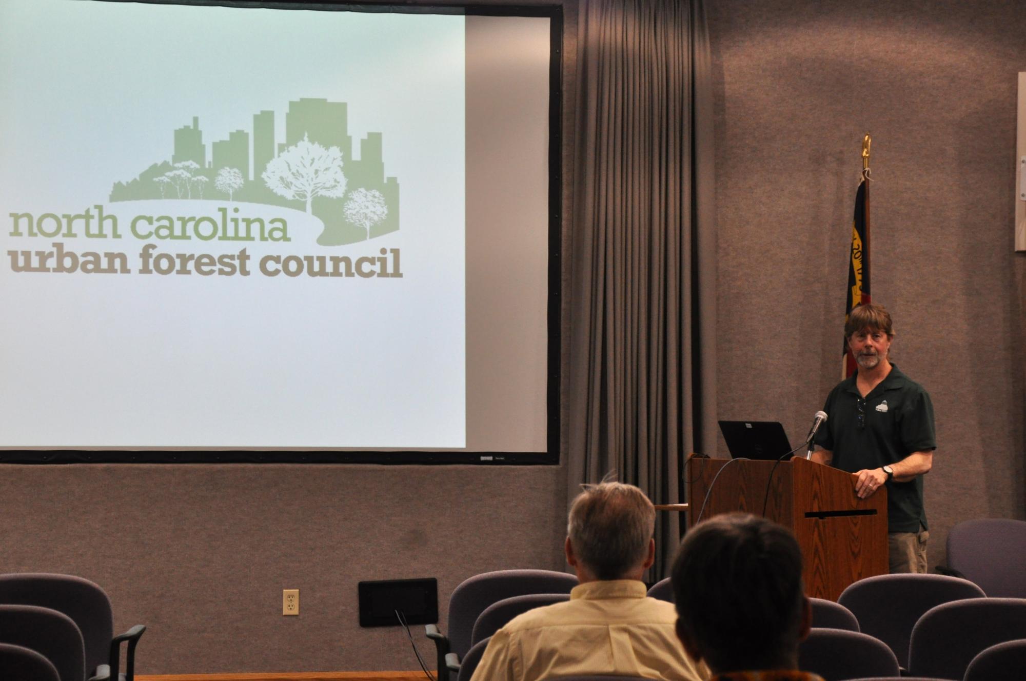 A man making a presentation in an auditorium