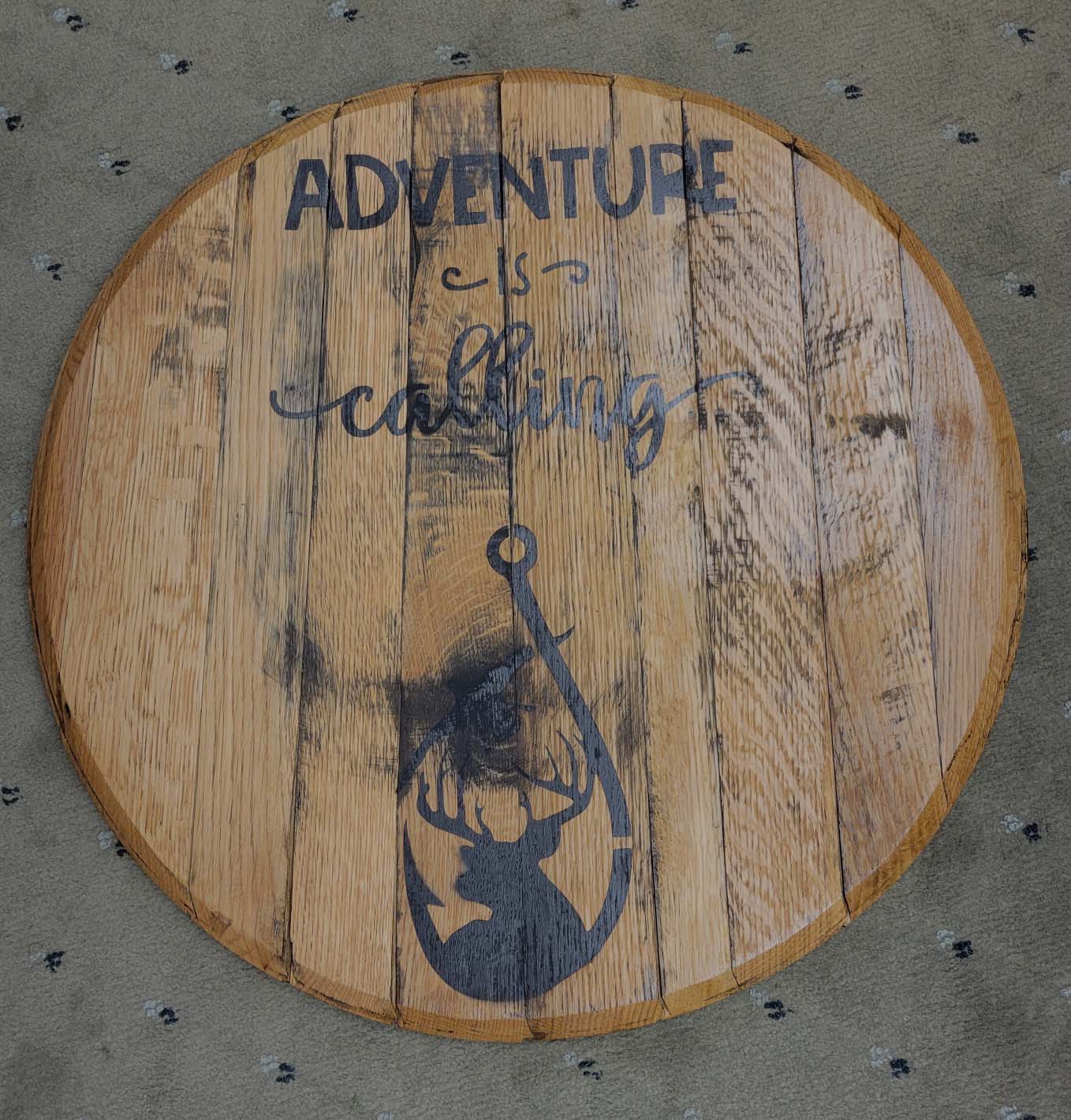 Brown handmade wooden sign with writing and a deer in a fishing hook