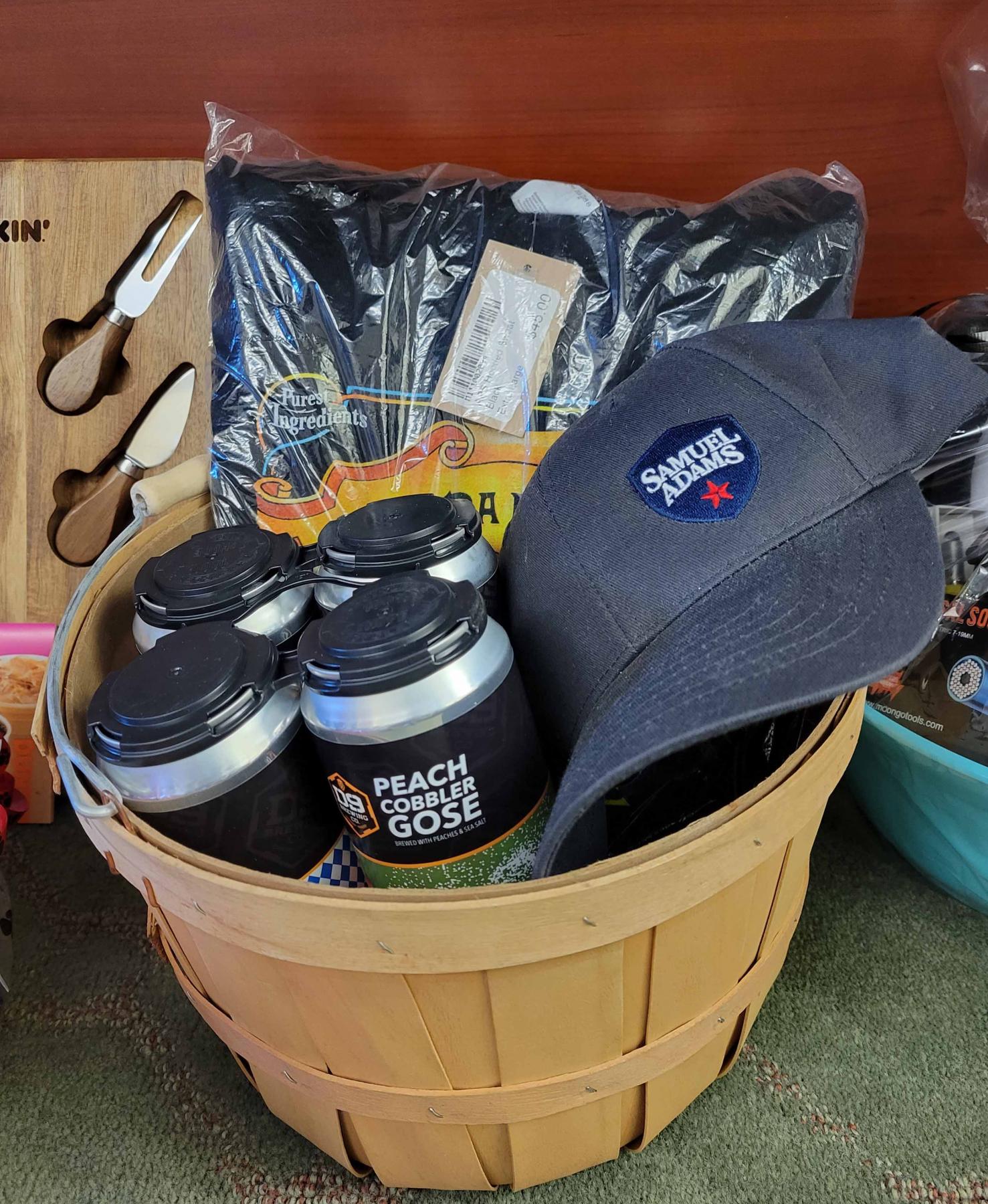 wooden basket filled with beer, a hat, and some clothes