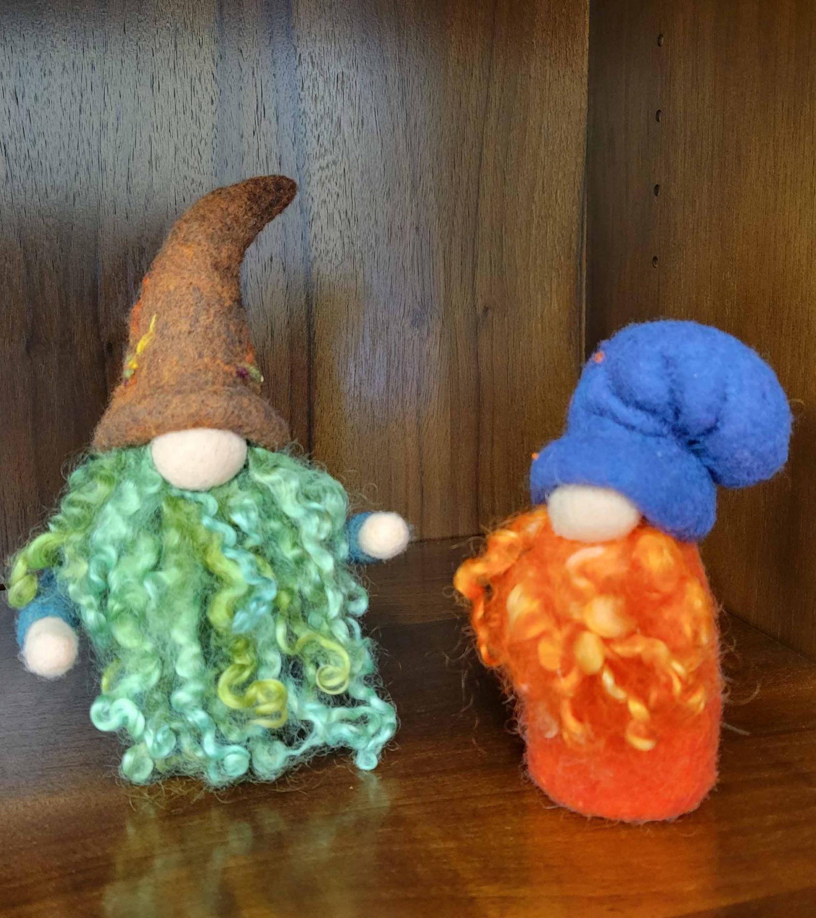 Two needle folded gnomes. One with brown hat and green beard, another with blue hat and orange beard