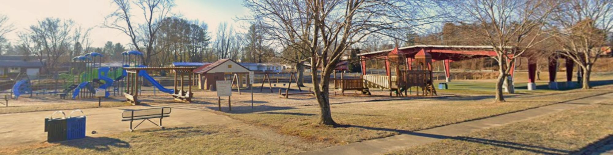 Playground, bench, bathrooms, and a basketball course