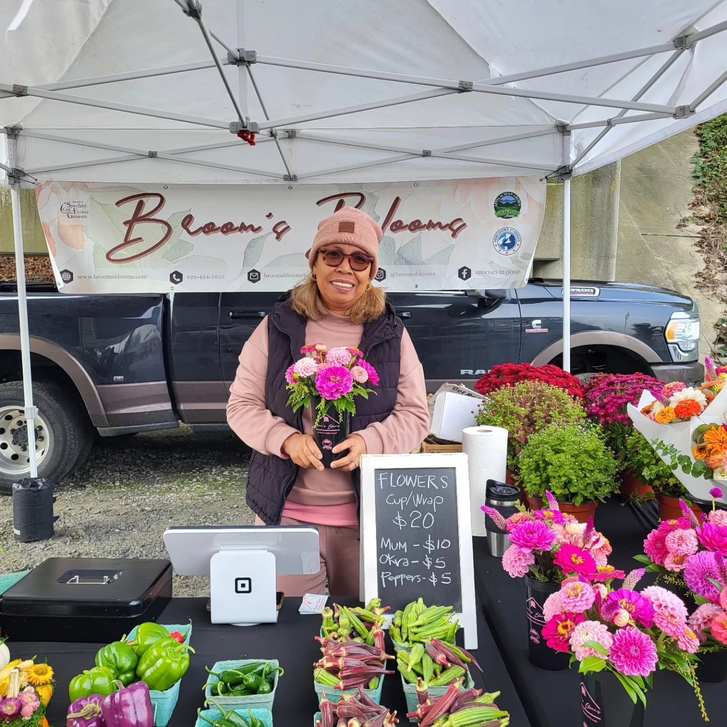 Vendor from GO Pink Day wearing pink and selling flowers
